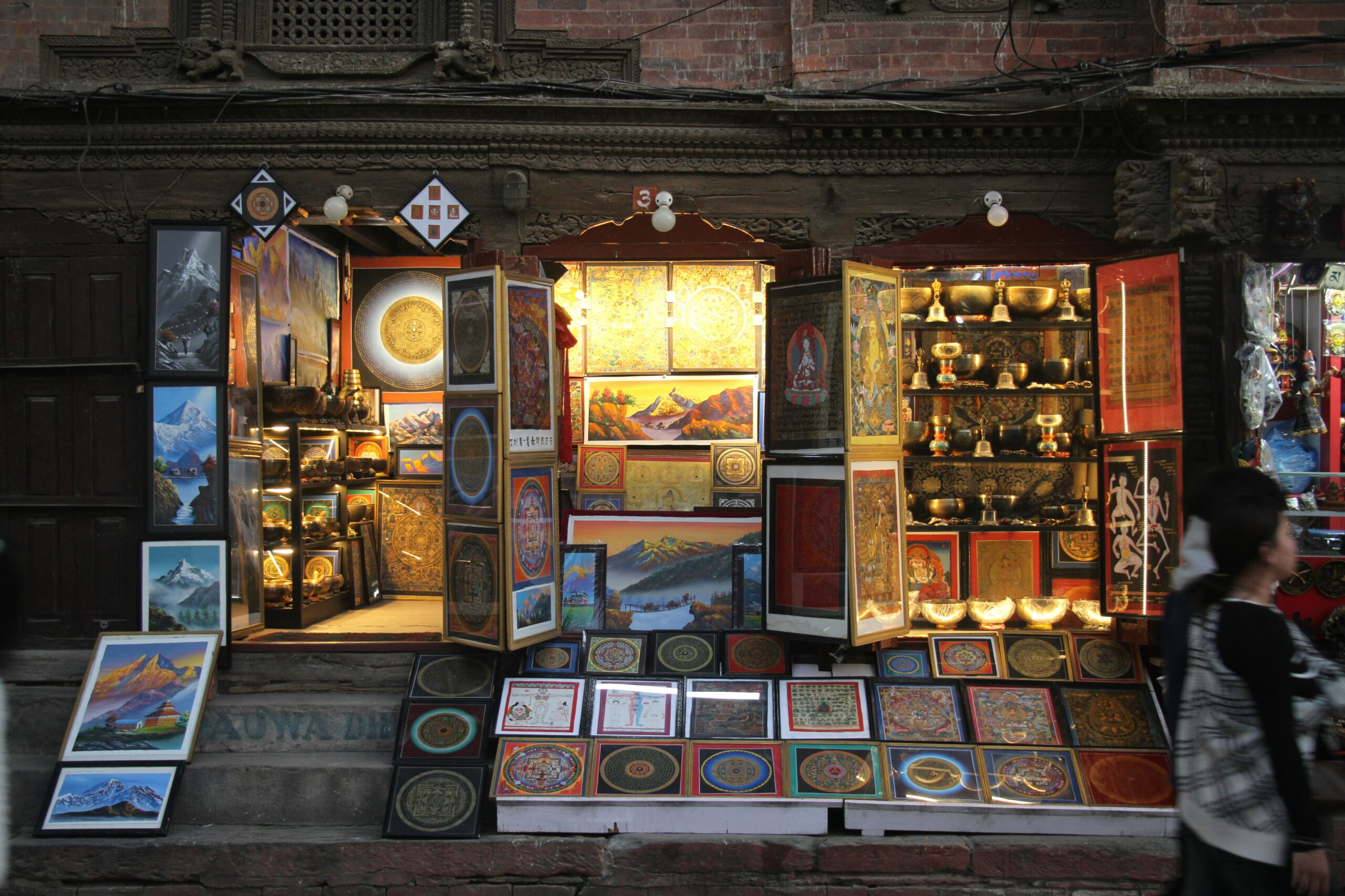 Nepal cultural experiences: Artisan creating traditional Thangka paintings in a local Kathmandu shop